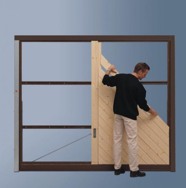 Picture showing man making bespoke timber garage door on Hormann OFI door chassis